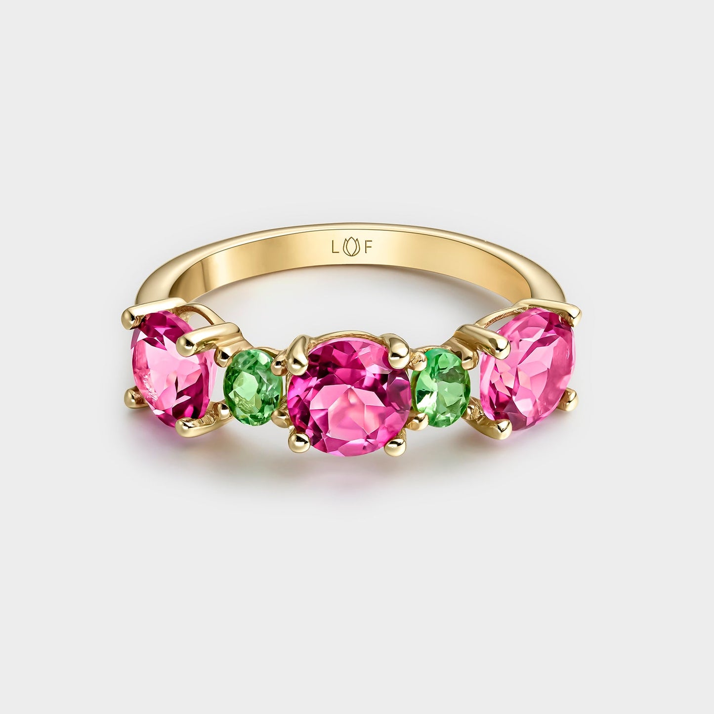 ANILLO DE ORO AMARILLO DE 18KTS CON 3 TOPACIOS ROSAS DE 6MM Y 2 TSAVORITAS OVALES DE 4X3MM