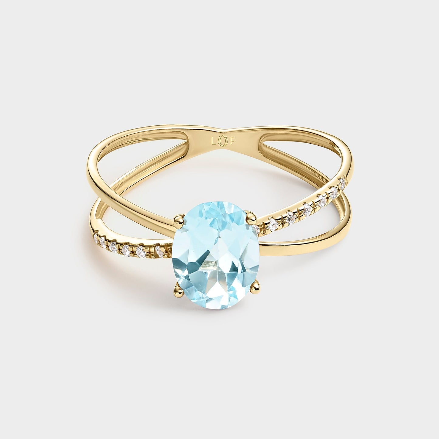 ANILLO DOBLE HILERA TOPACIO OVAL Y CIRCONITAS
EN ORO DE 18 QUILATES.