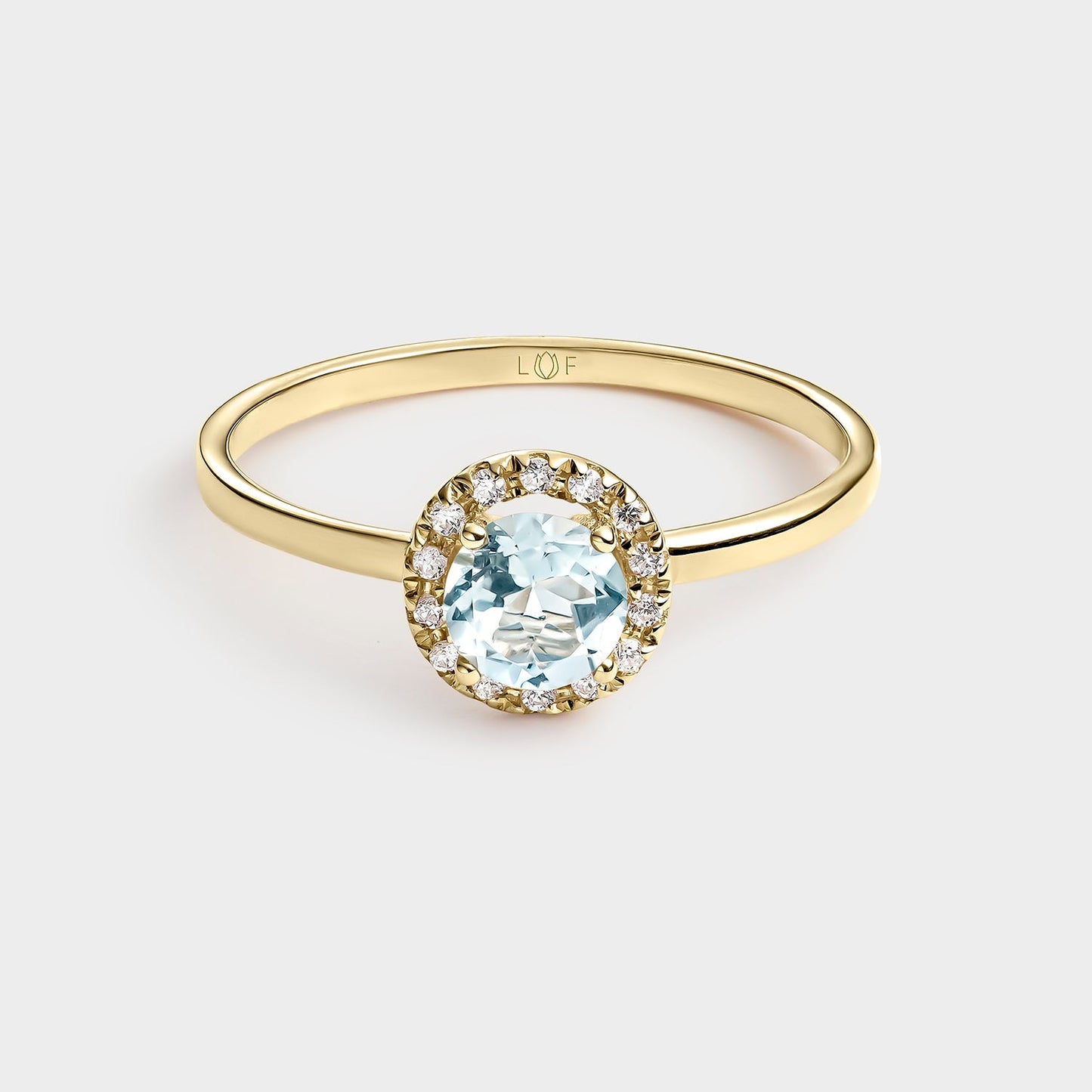 ANILLO TOPACIO 5MM Y CIRCONITAS EN ORO DE 18 QUILATES.