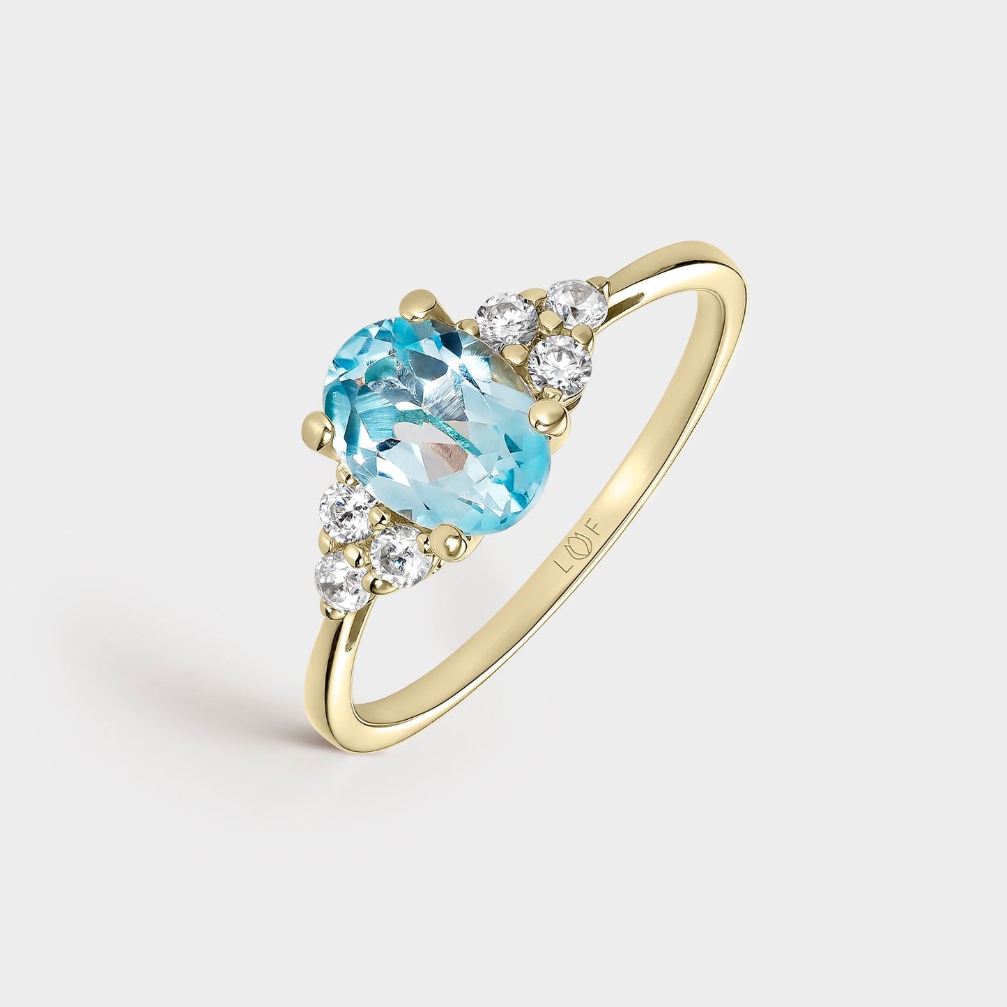 Sortija oro amarillo circonitas y topacio azul fino 8*6