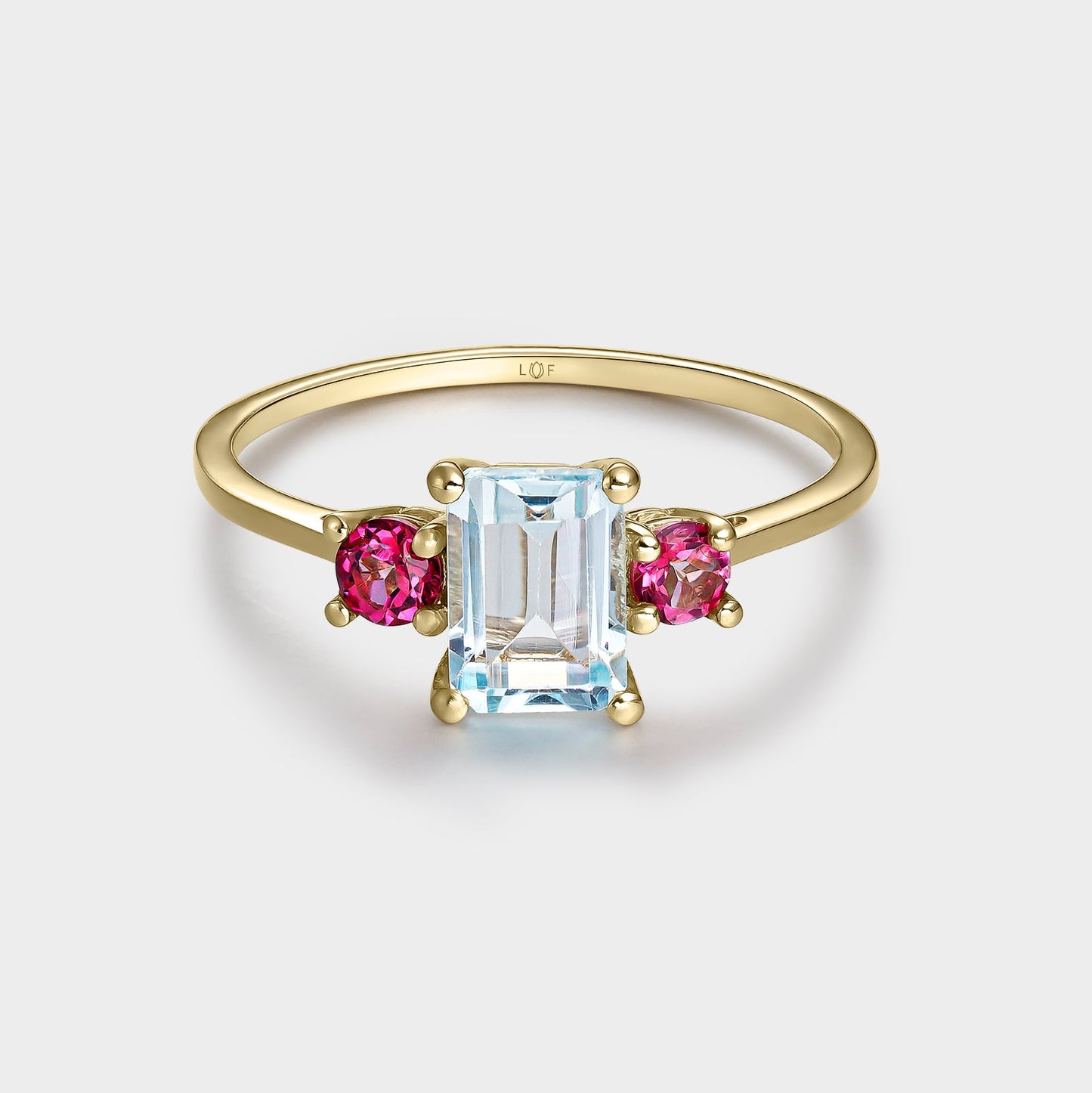 Anillo trilogía topacio octogonal 7*5 y topacios rosas 3mm con circonitas
en oro de 18 quilates.